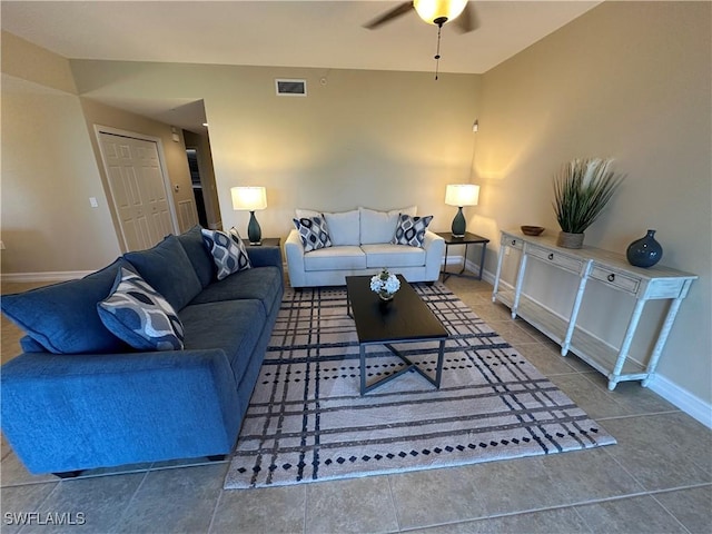 living room with ceiling fan and tile patterned flooring