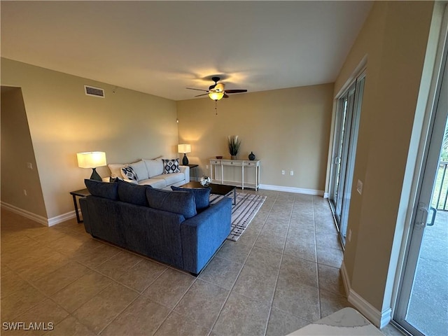 living room with tile patterned floors and ceiling fan