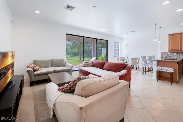 tiled living room with a chandelier