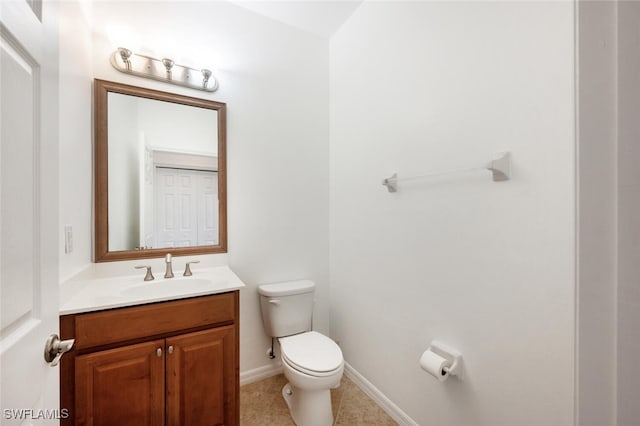 bathroom with tile patterned floors, vanity, and toilet