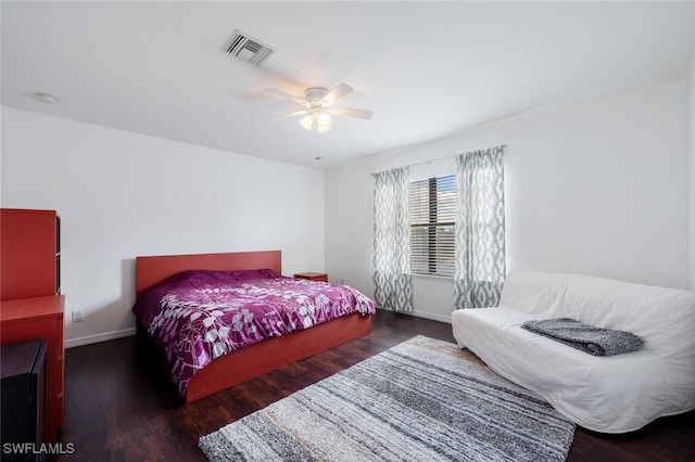 bedroom featuring ceiling fan and dark wood-type flooring