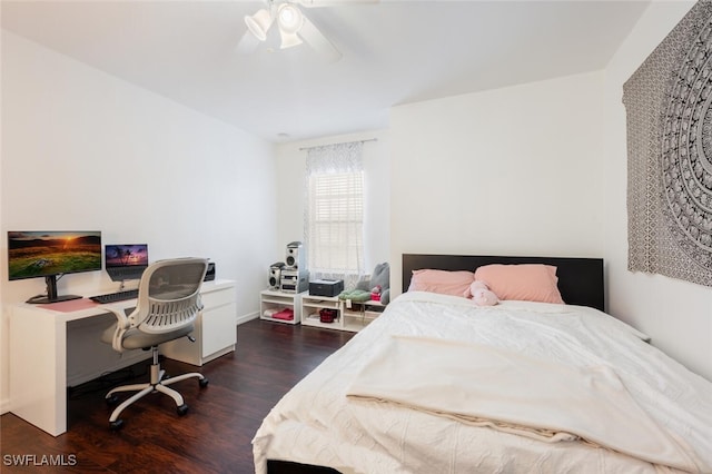 bedroom with dark hardwood / wood-style flooring and ceiling fan