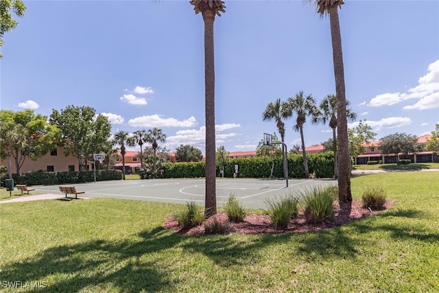 view of sport court with a lawn