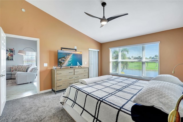 bedroom with light colored carpet, vaulted ceiling, and ceiling fan