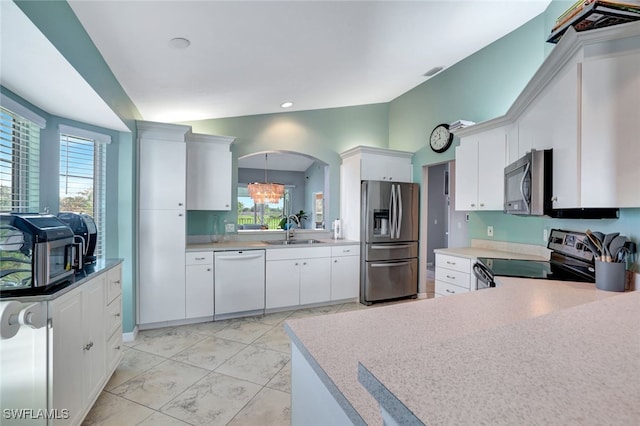 kitchen with white cabinetry, sink, stainless steel appliances, and plenty of natural light