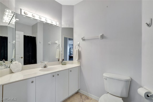 bathroom with tile patterned floors, vanity, and toilet