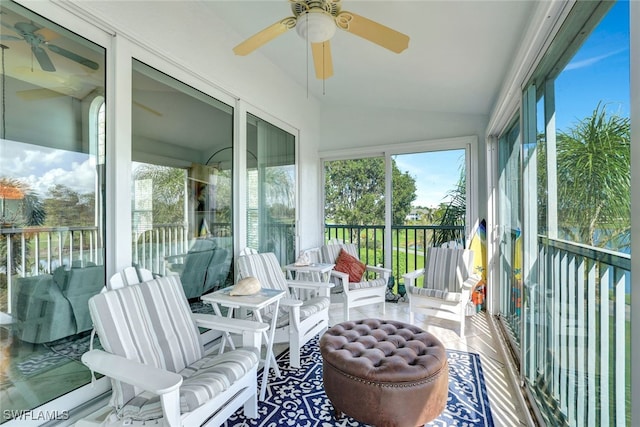 sunroom / solarium featuring ceiling fan and lofted ceiling