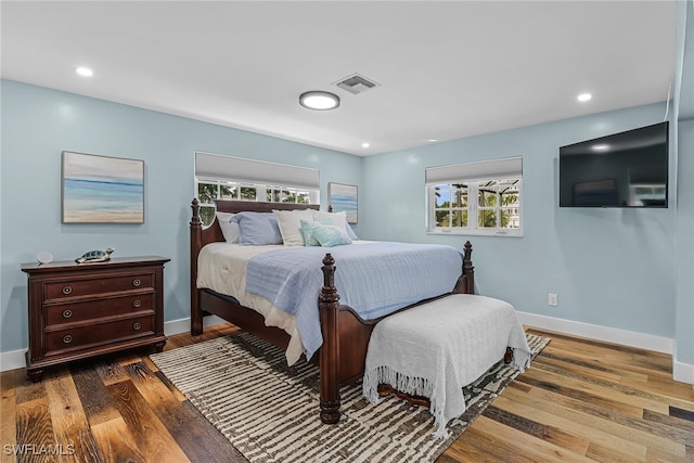 bedroom featuring baseboards, multiple windows, and visible vents