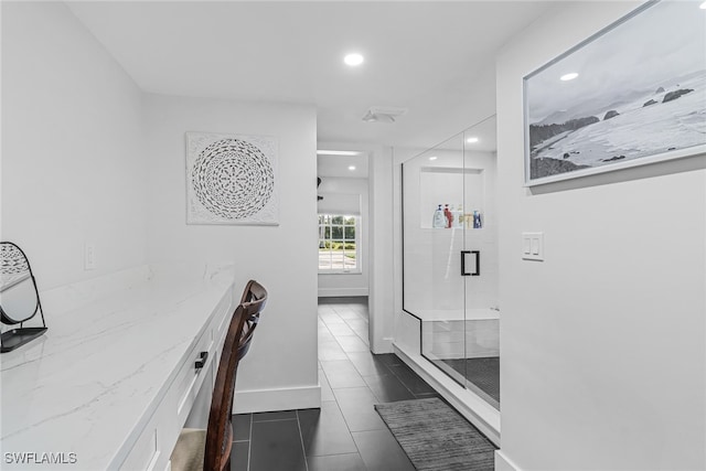 hall with dark tile patterned flooring, baseboards, and recessed lighting