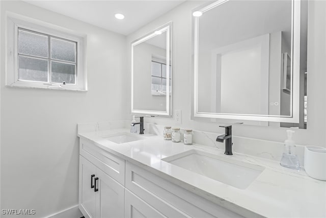 full bath with a sink and double vanity