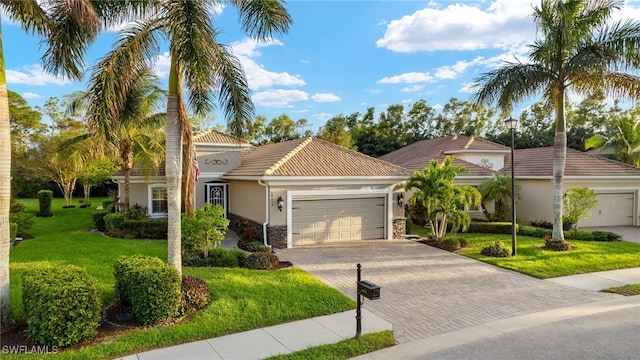 mediterranean / spanish-style house with a front yard and a garage