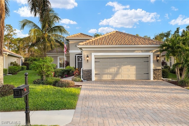 mediterranean / spanish-style home featuring a garage and a front lawn