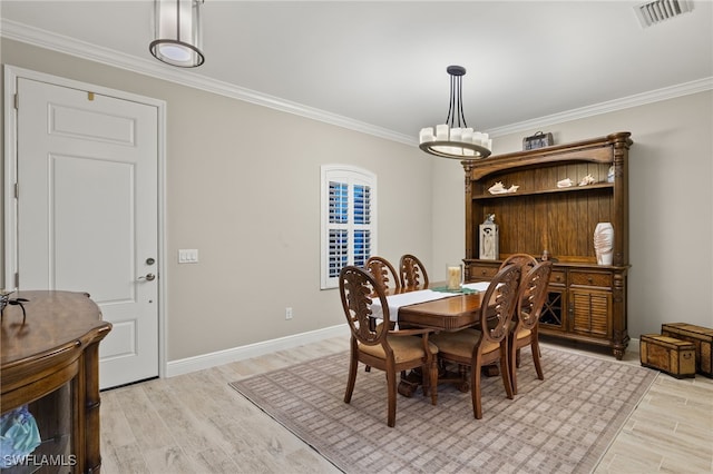 dining area with crown molding and light wood-type flooring