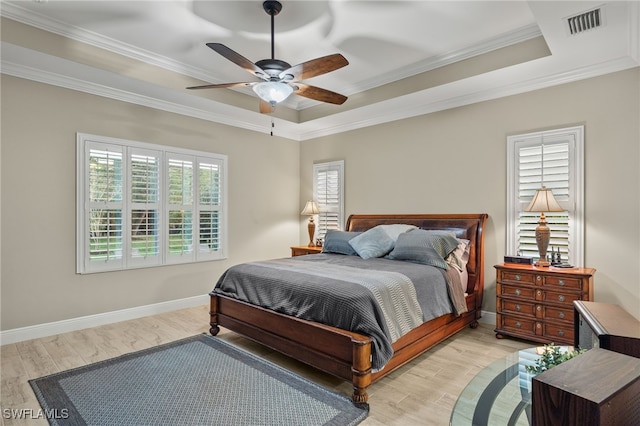 bedroom with a raised ceiling, ceiling fan, light hardwood / wood-style flooring, and ornamental molding