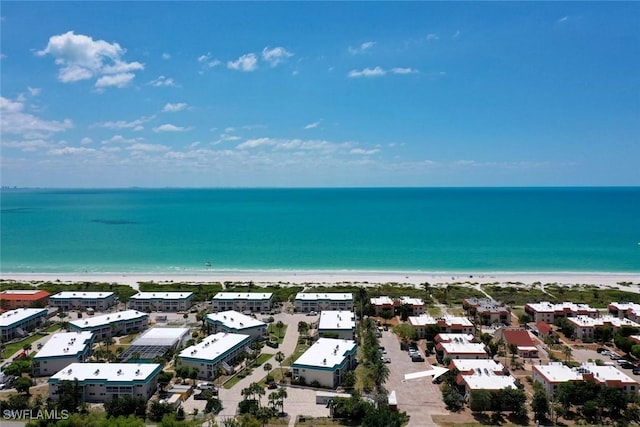 drone / aerial view featuring a water view and a view of the beach