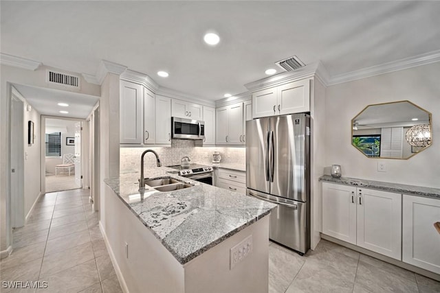 kitchen featuring sink, stainless steel appliances, light tile patterned floors, light stone counters, and white cabinets