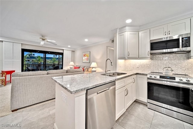 kitchen featuring kitchen peninsula, white cabinetry, sink, and appliances with stainless steel finishes