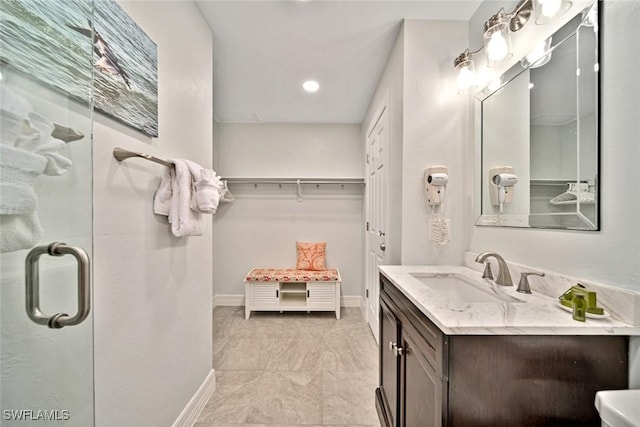 bathroom featuring vanity and an enclosed shower