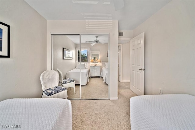 bedroom featuring ceiling fan, a closet, and carpet