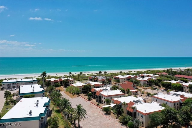 birds eye view of property with a view of the beach and a water view