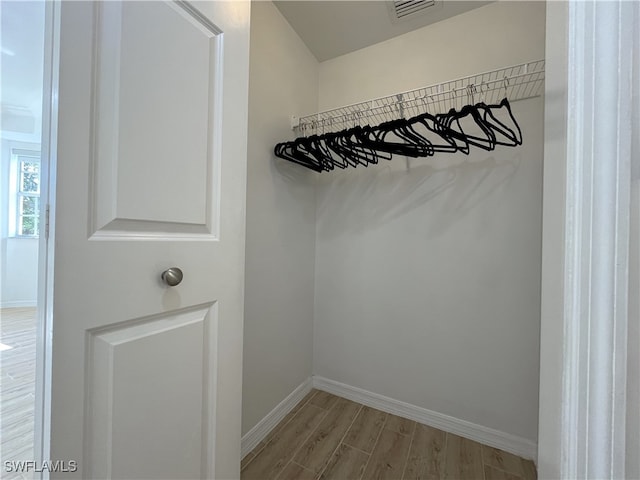 walk in closet with light wood-type flooring