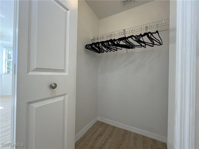 walk in closet featuring light wood-style flooring and visible vents