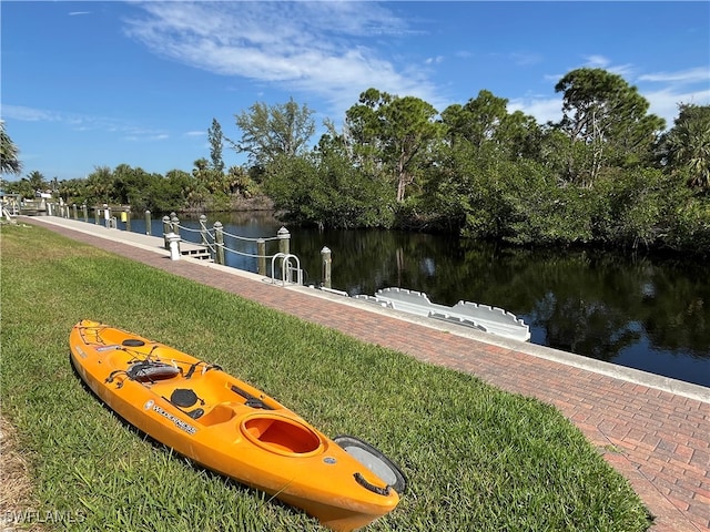 dock area featuring a water view and a lawn