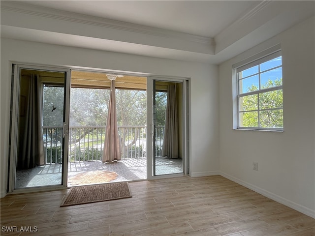 doorway featuring light wood-type flooring and crown molding