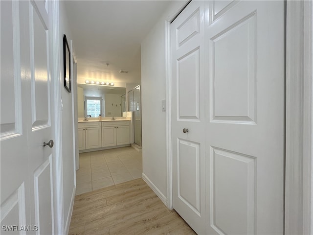 hall with light hardwood / wood-style floors