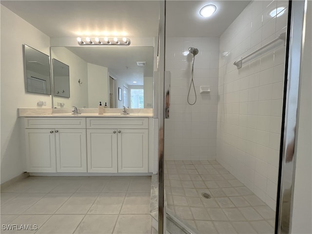 bathroom featuring tile patterned floors, vanity, and tiled shower