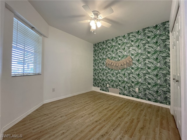 unfurnished room with hardwood / wood-style flooring and ceiling fan