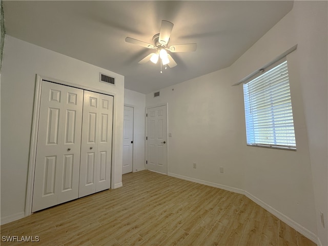 unfurnished bedroom featuring light wood-type flooring and ceiling fan