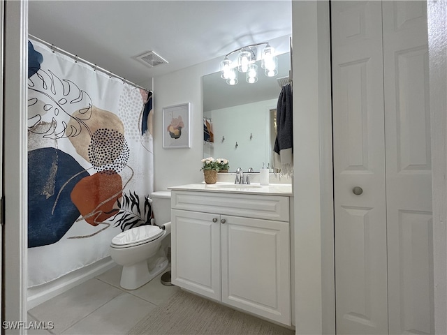 bathroom featuring toilet, vanity, and tile patterned floors