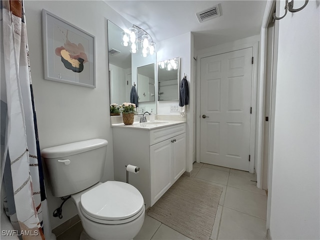 bathroom featuring tile patterned flooring, vanity, and toilet