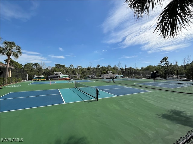 view of tennis court with basketball hoop