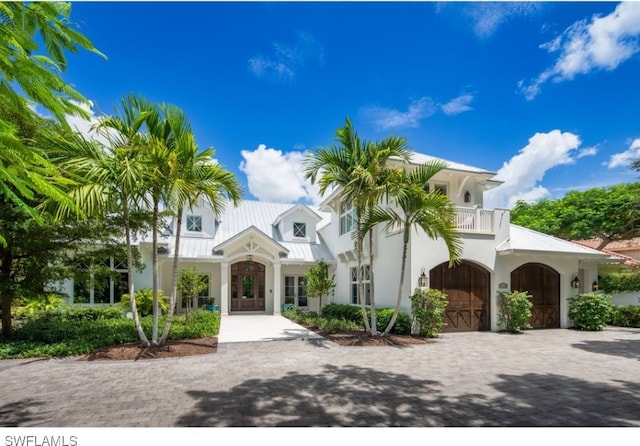 mediterranean / spanish-style home with french doors and a balcony