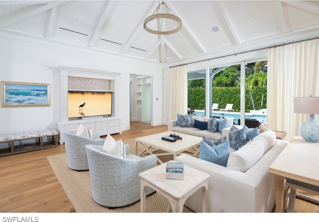 living room featuring light hardwood / wood-style floors, beam ceiling, and high vaulted ceiling