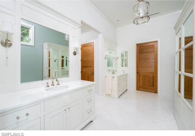 bathroom featuring tile patterned flooring, vanity, and crown molding