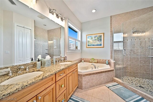 bathroom featuring tile patterned flooring, vanity, and separate shower and tub