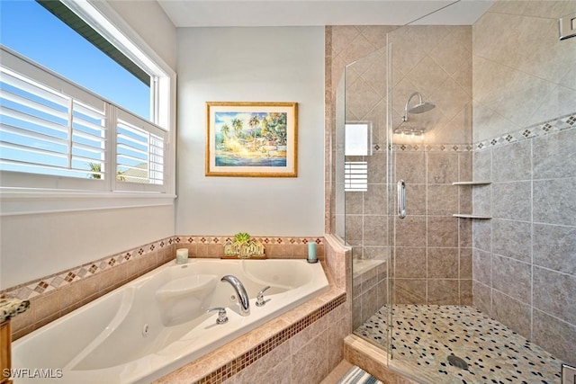 bathroom featuring shower with separate bathtub