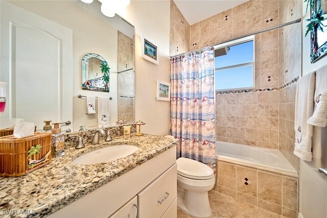 full bathroom with tile patterned flooring, shower / bath combo, toilet, and vanity