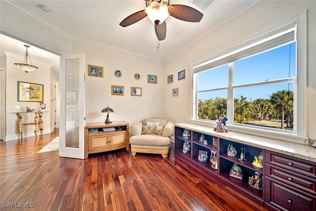 sitting room featuring dark hardwood / wood-style floors, ceiling fan, and ornamental molding