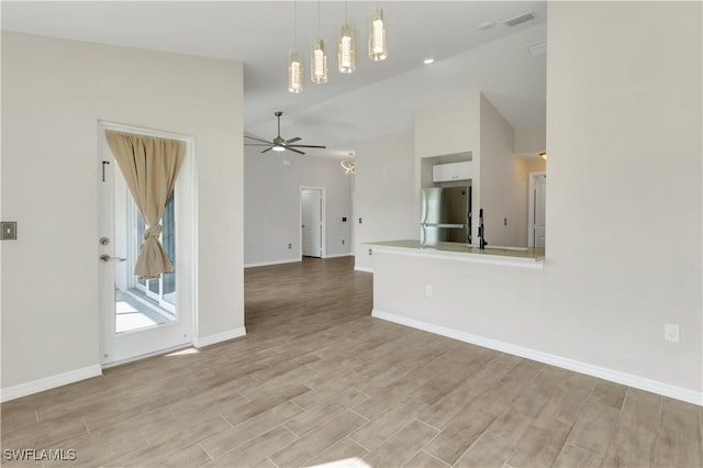 unfurnished living room featuring light wood-type flooring and ceiling fan