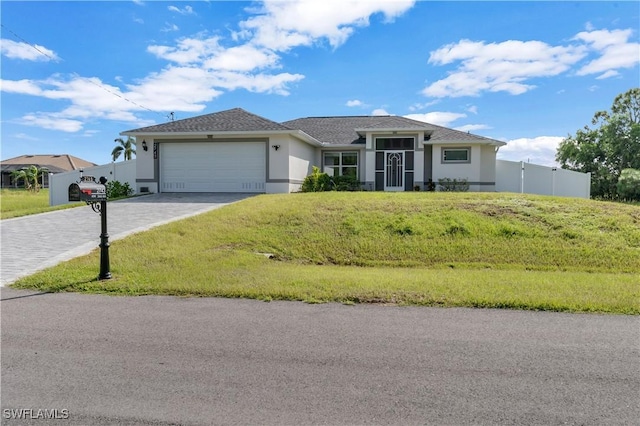 single story home with a garage and a front yard