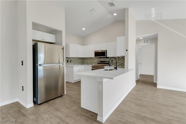 kitchen with light wood-type flooring, stainless steel appliances, white cabinetry, and sink