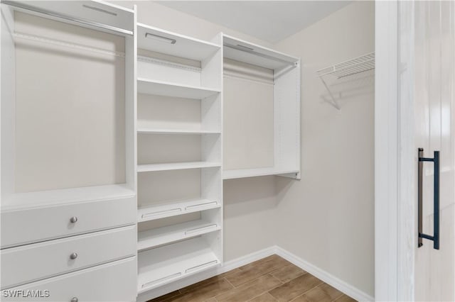 spacious closet featuring hardwood / wood-style floors