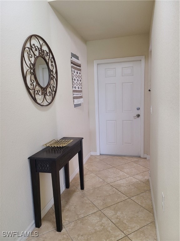 entryway with light tile patterned flooring