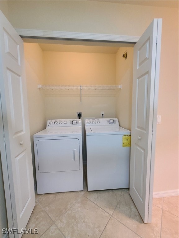 washroom featuring light tile patterned floors and separate washer and dryer