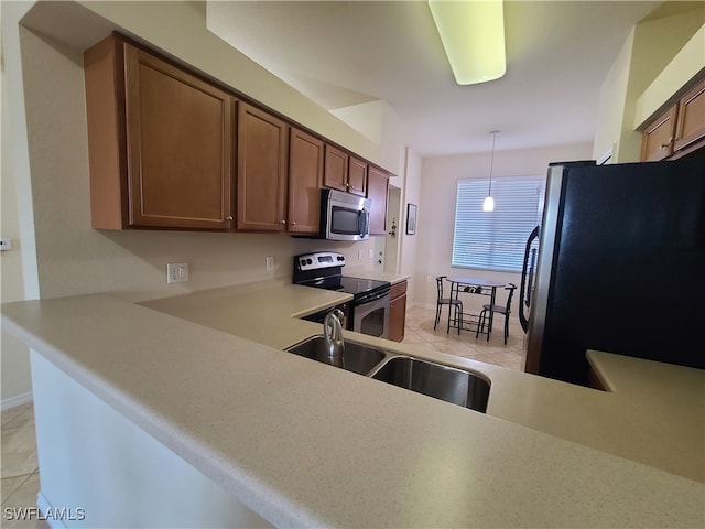 kitchen featuring sink, hanging light fixtures, light tile patterned floors, appliances with stainless steel finishes, and kitchen peninsula