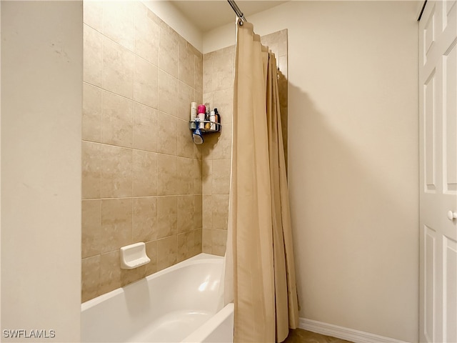 bathroom with shower / bathtub combination with curtain